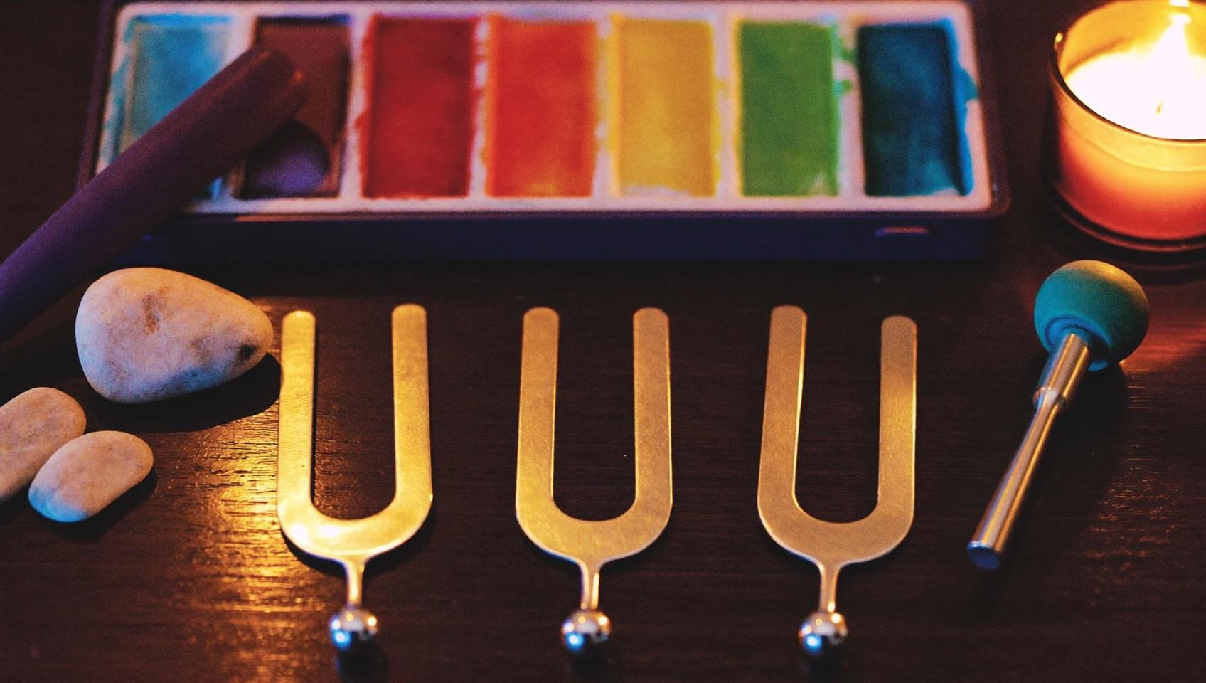 Tuning forks, smooth stones and watercolors by candlelight